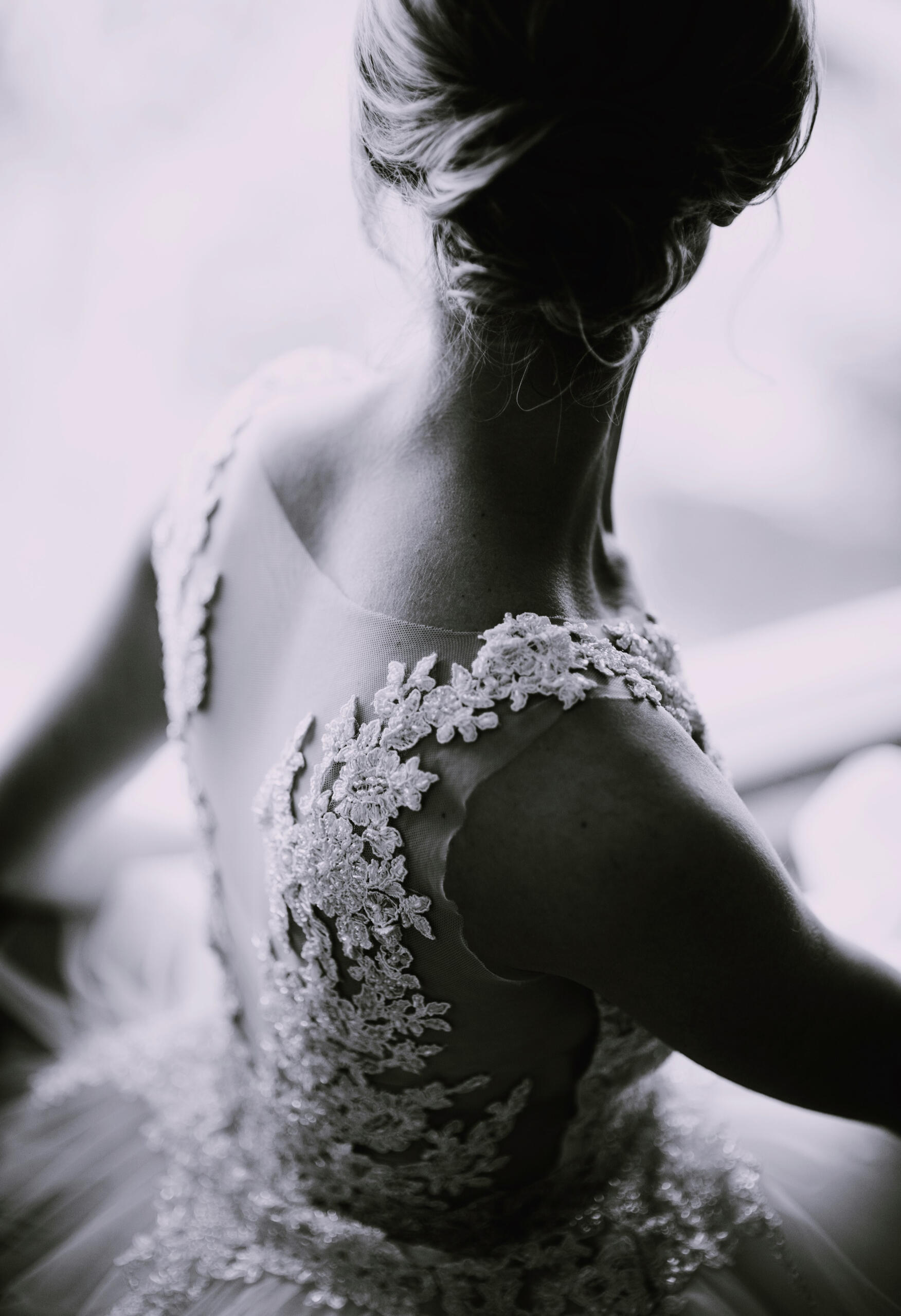 Bridal gown fitting – expert alterations for weddings and special events Back of woman in elegant lace gown – wedding dress alteration example in Hamilton, NJ